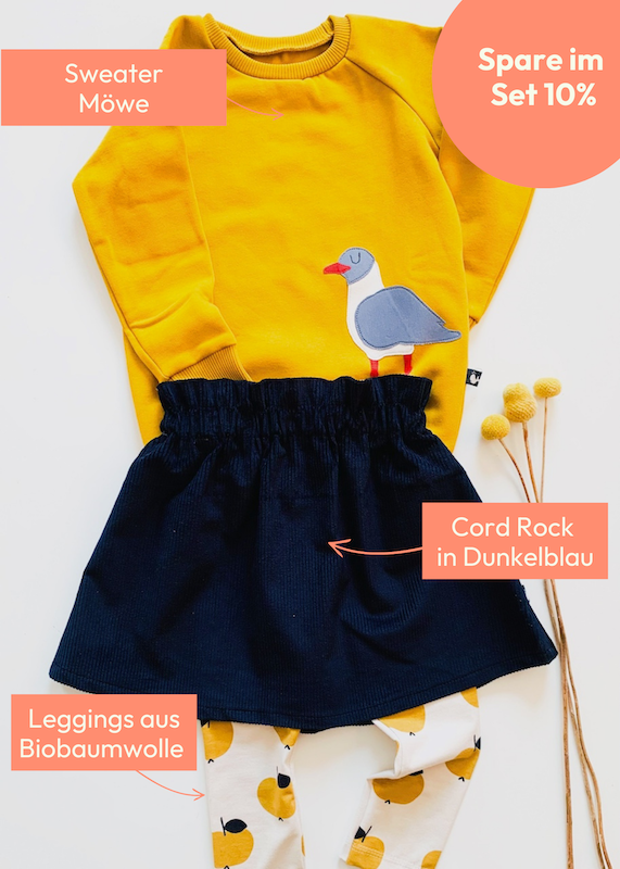 Fröhliches Kinder Outfit mit Kinder Pullover mit Möwe, dunkelblauen Cord Rock und Leggings mit gelben Äpfeln aus Biobaumwolle von internaht